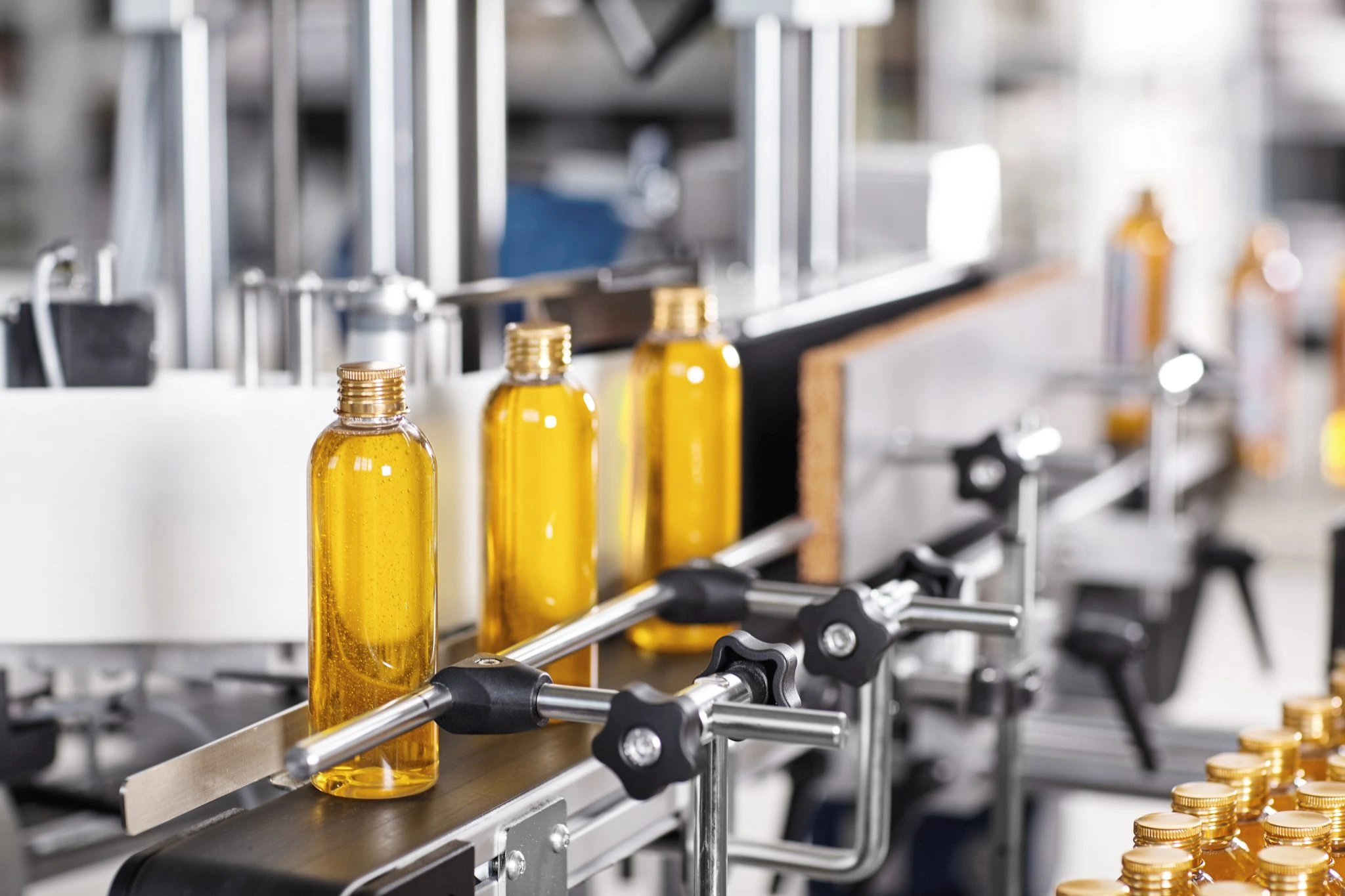 Pure ghee in transparent bottles from ghee processing plant